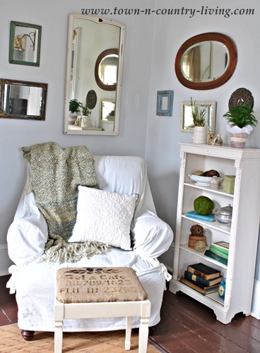 Comfy chair and vintage mirrors in the family room - www.town-n-country-living.com