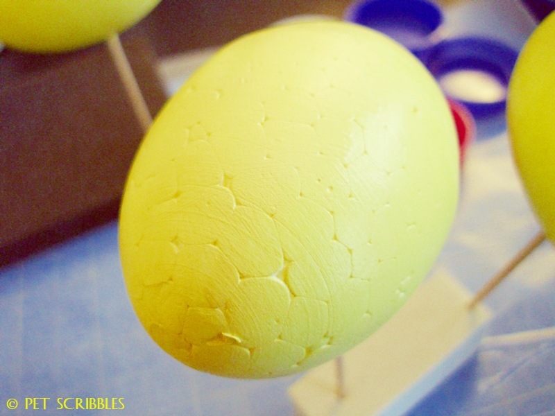 yellow painted foam egg drying